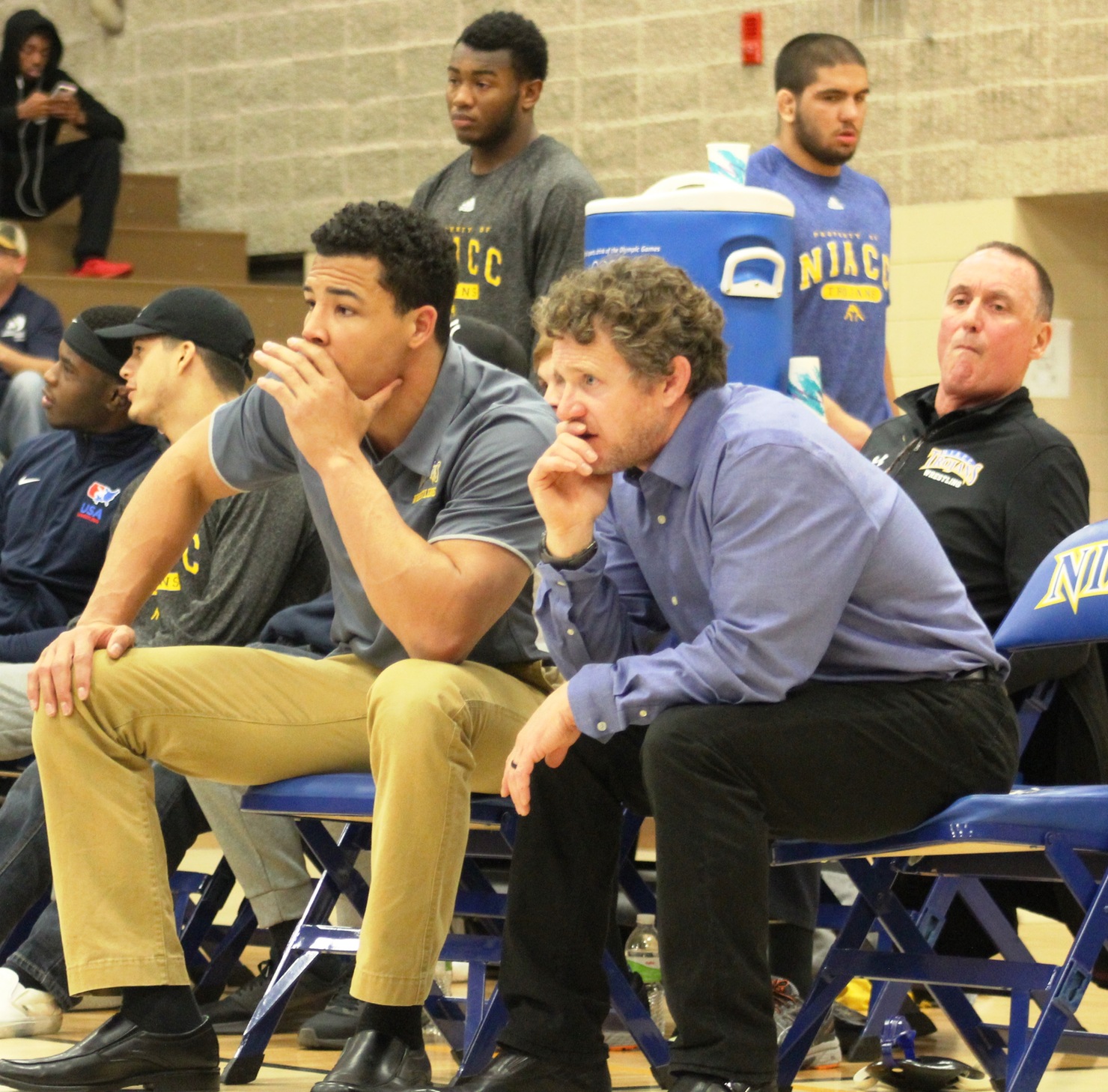 NIACC coaches Steve Kelly (right) and Basil Minto on the sidelines in a home dual meet earlier this season.