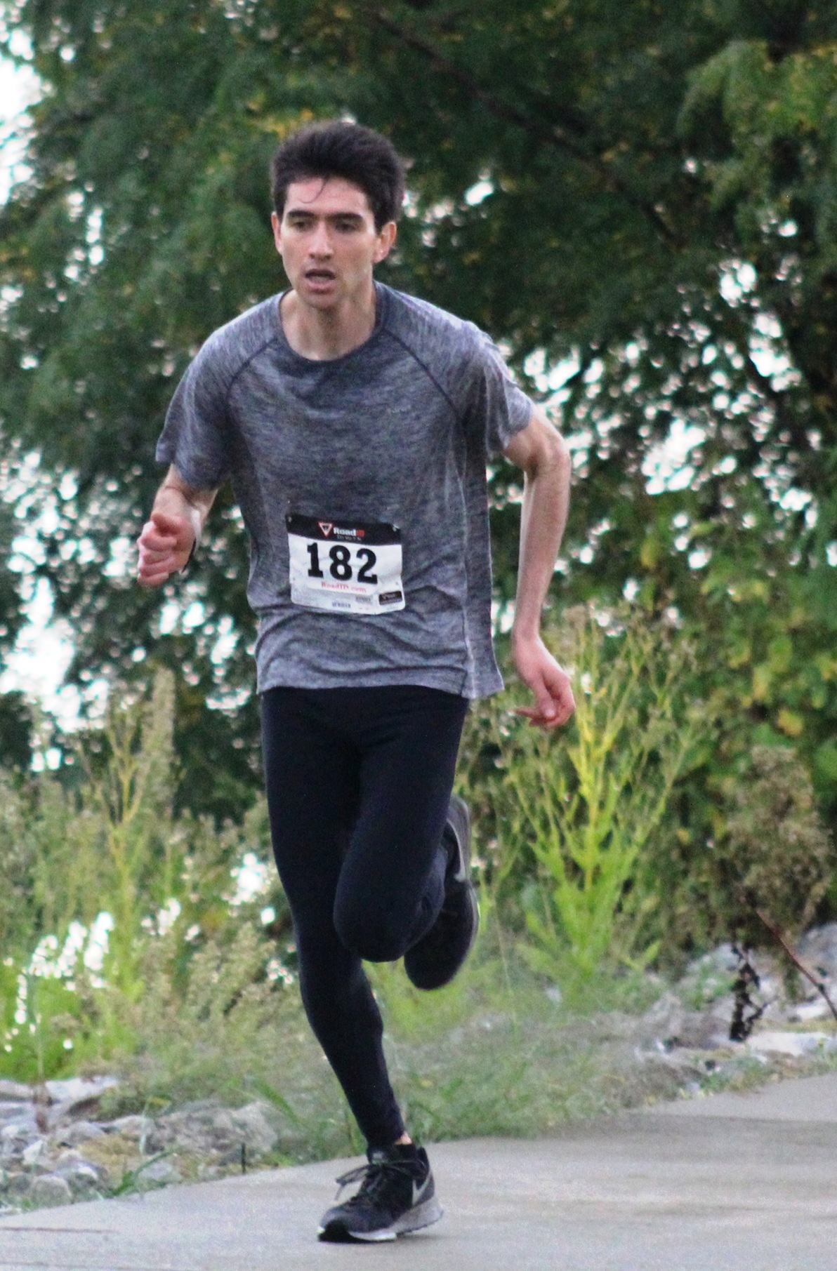 Leonardo Figueiras runs to a first-place finish in the Robert's Run four-mile run on Saturday.