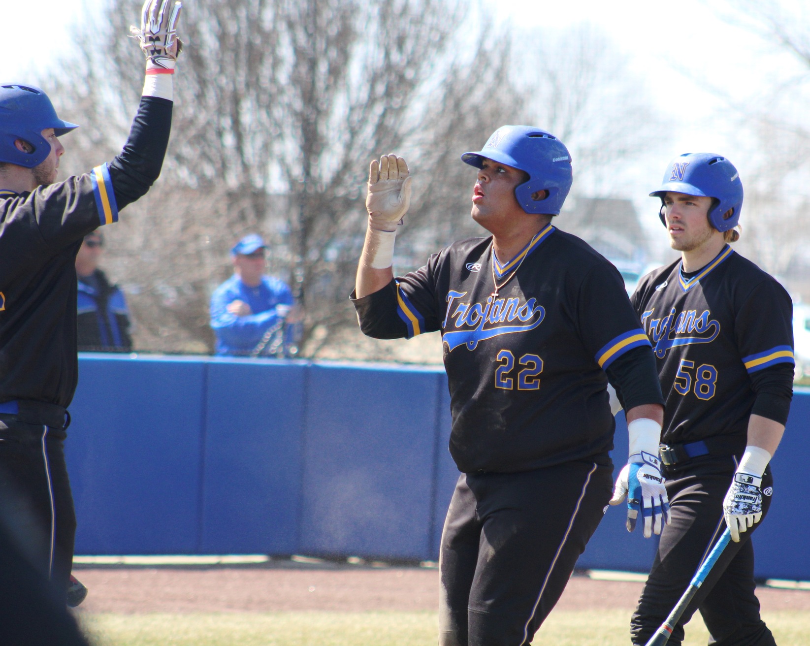 NIACC's Kamrin Arons (22) gets a high five after scoring a run in series against Kirkwood this season.
