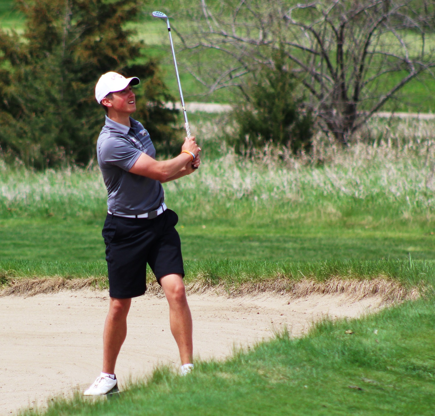 NIACC's Ben Boerjan chips out of the sand at the regional tournament.