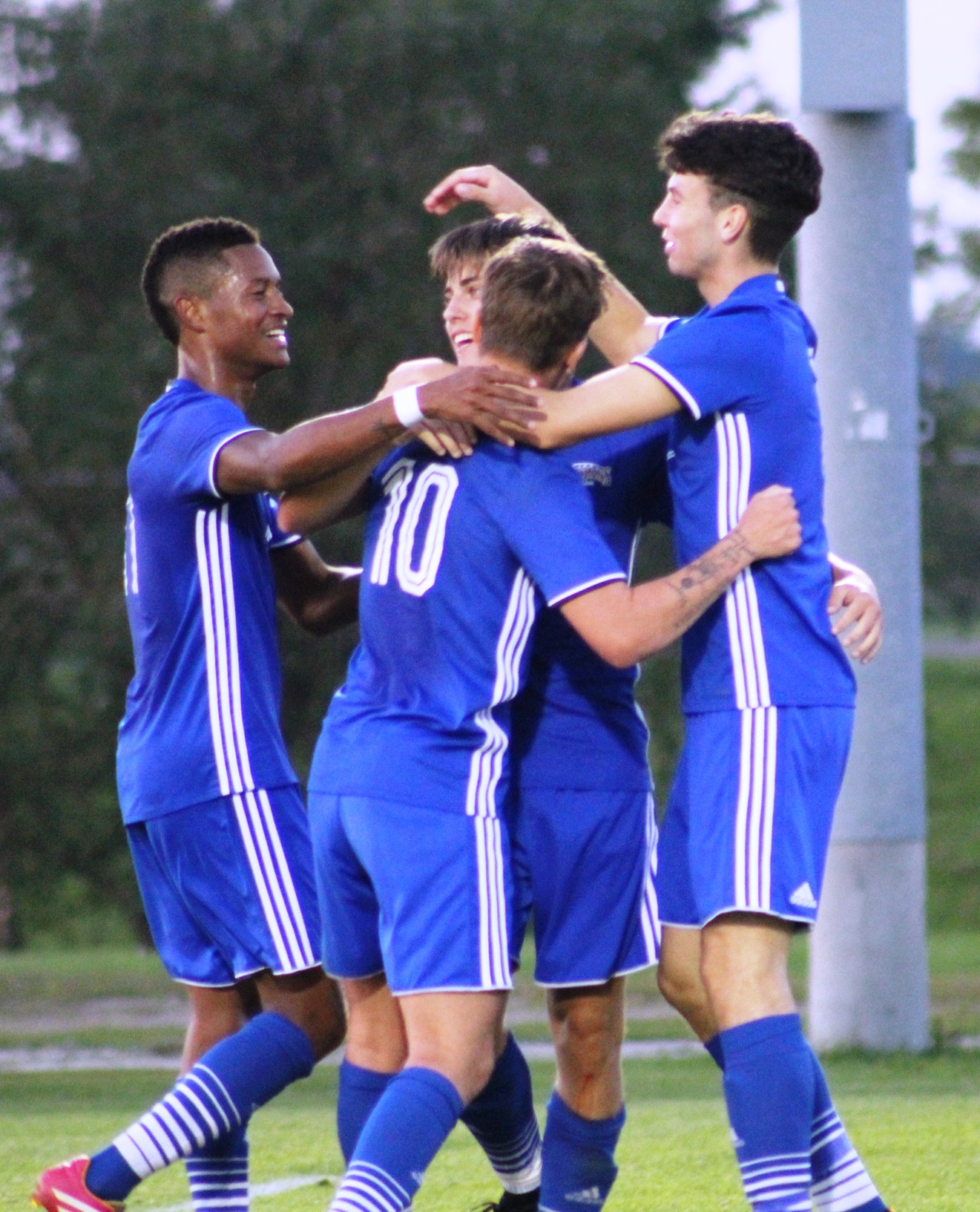 NIACC players celebrate with Michael Donovan (10) and Mike Merchant (far left) after Donovan scored a first-half goal on an assist from Merchant.