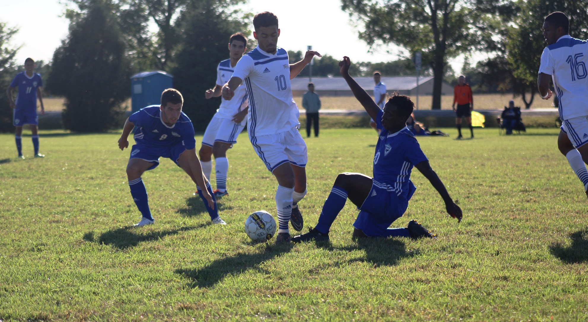 NIACC's Alex Scarano controls the ball in between two Iowa Western defenders in Saturday's ICCAC match.