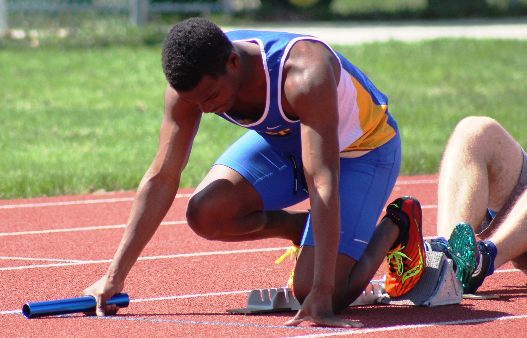 David Carter starts the Trojans' 4x400 relay last Saturday in Grinnell.