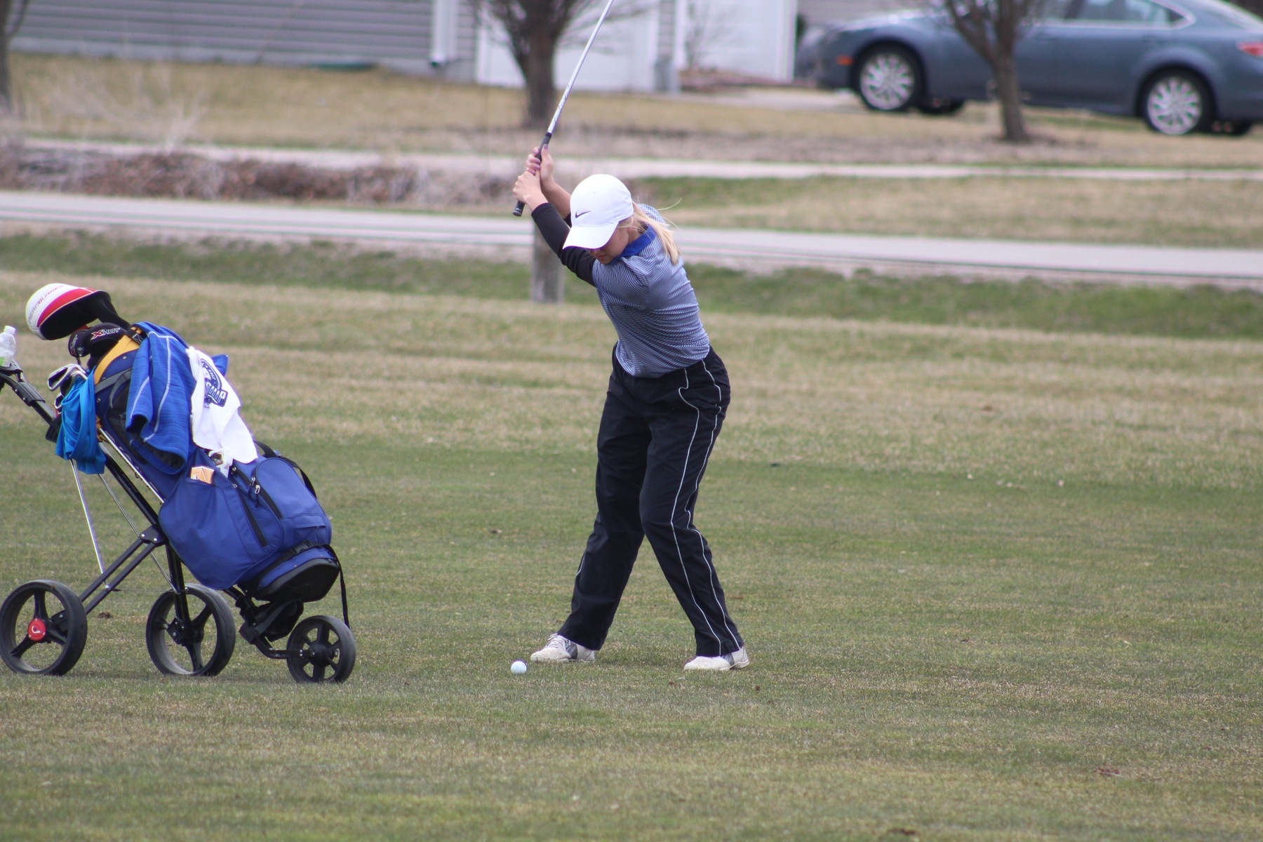 Courtney Tusler hits her approach shot to the green during first round of regional golf tournament Friday in Ankeny.