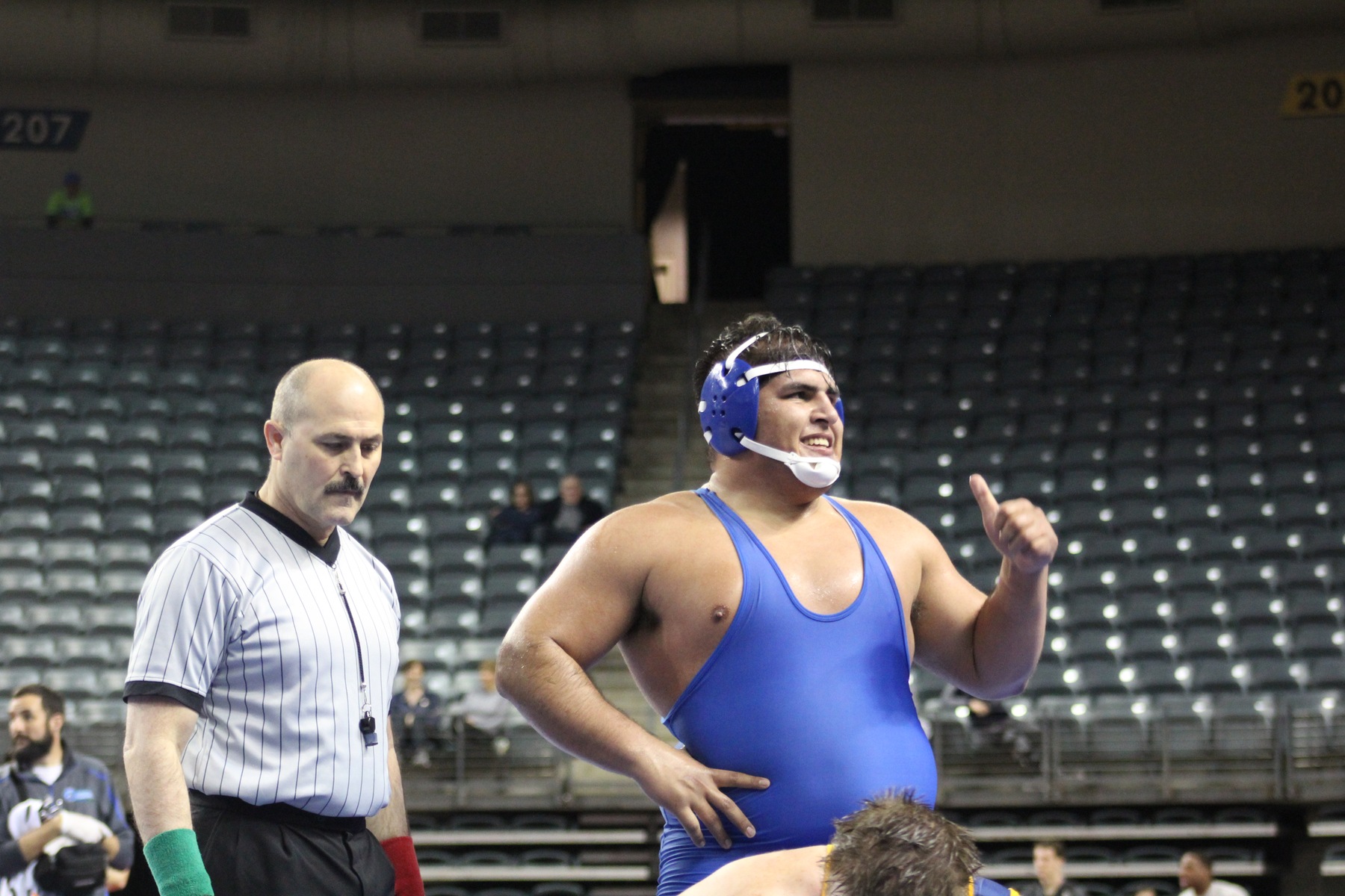Mario Pena gives the thumbs up sign after winning his quarterfinal round match at 285 pounds Friday night.