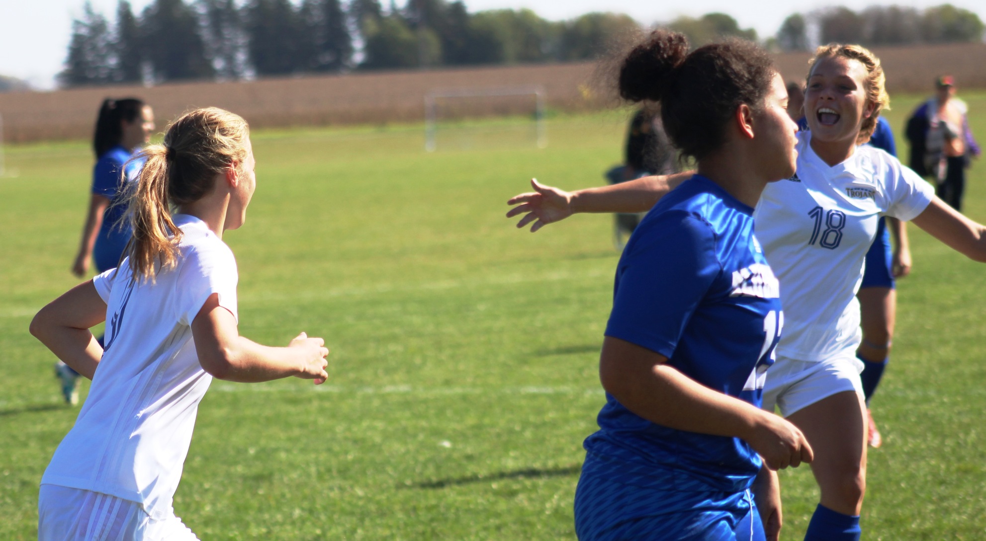 Jessica Altman (18) congratulates Lena Oliver after Oliver scored the Lady Trojans' first goal on Tuesday against DCTC.