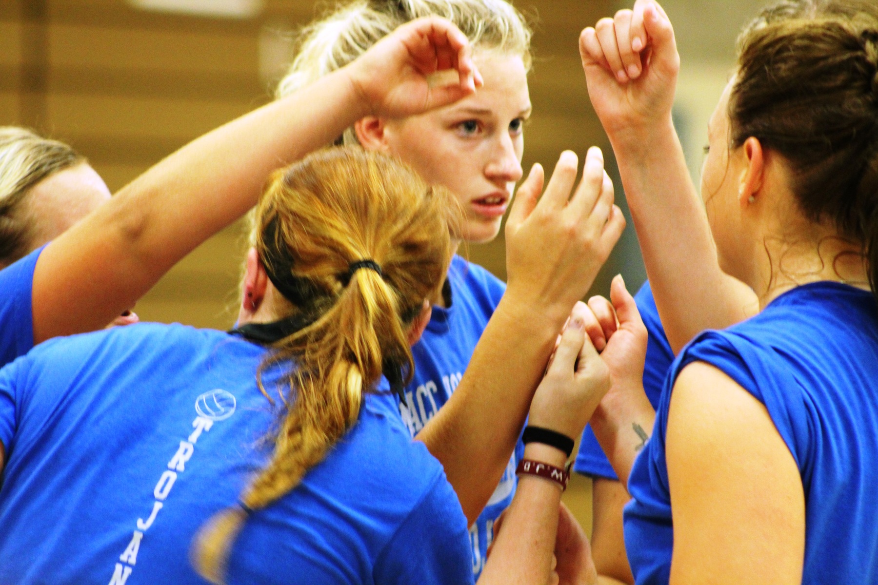 The NIACC volleyball team huddles up in a preseason scrimmage in the NIACC gym.