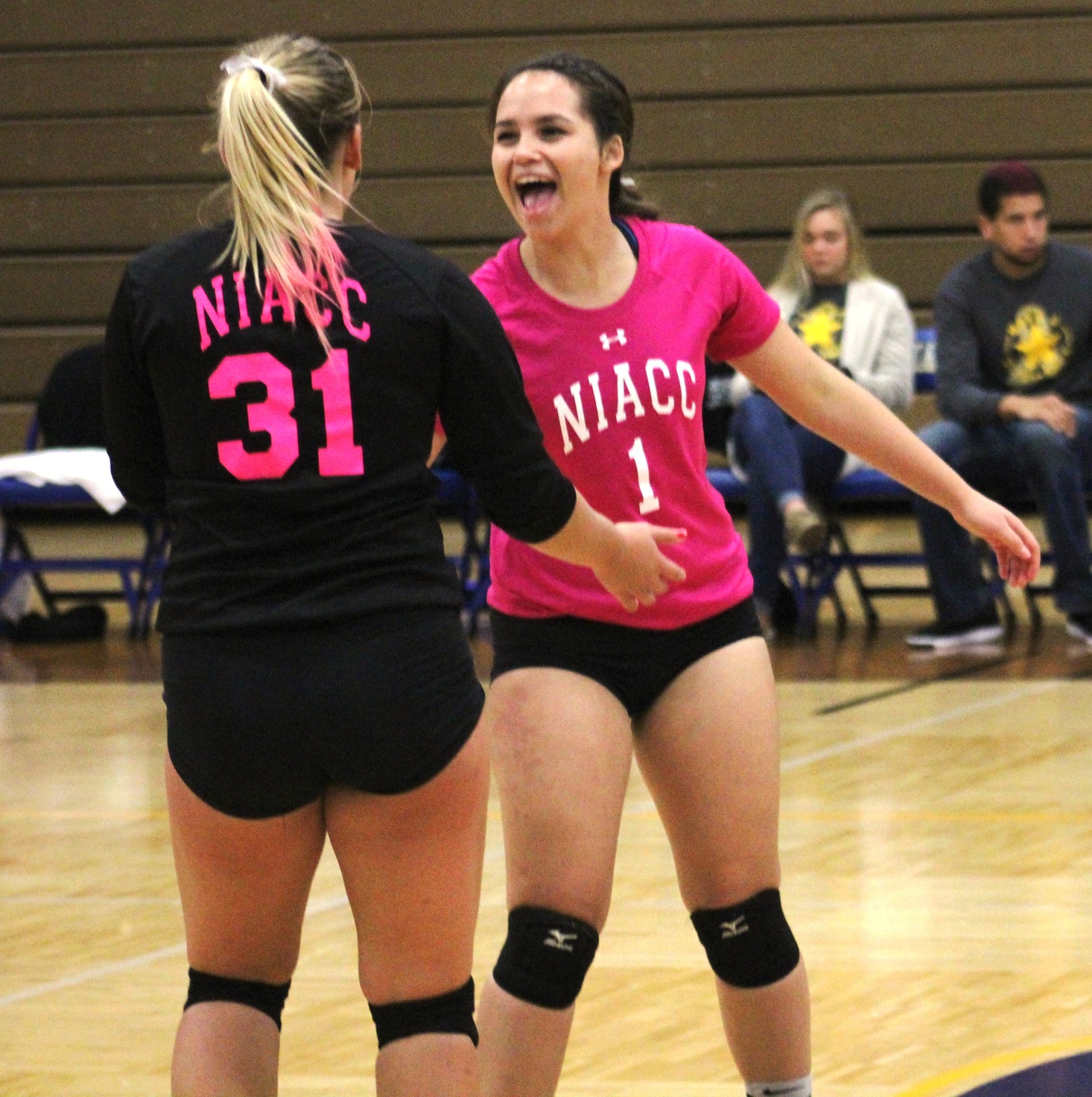 NIACC's Kyra Marquez (right) and Sammi Hyde celebrate a point in Wednesday's match.