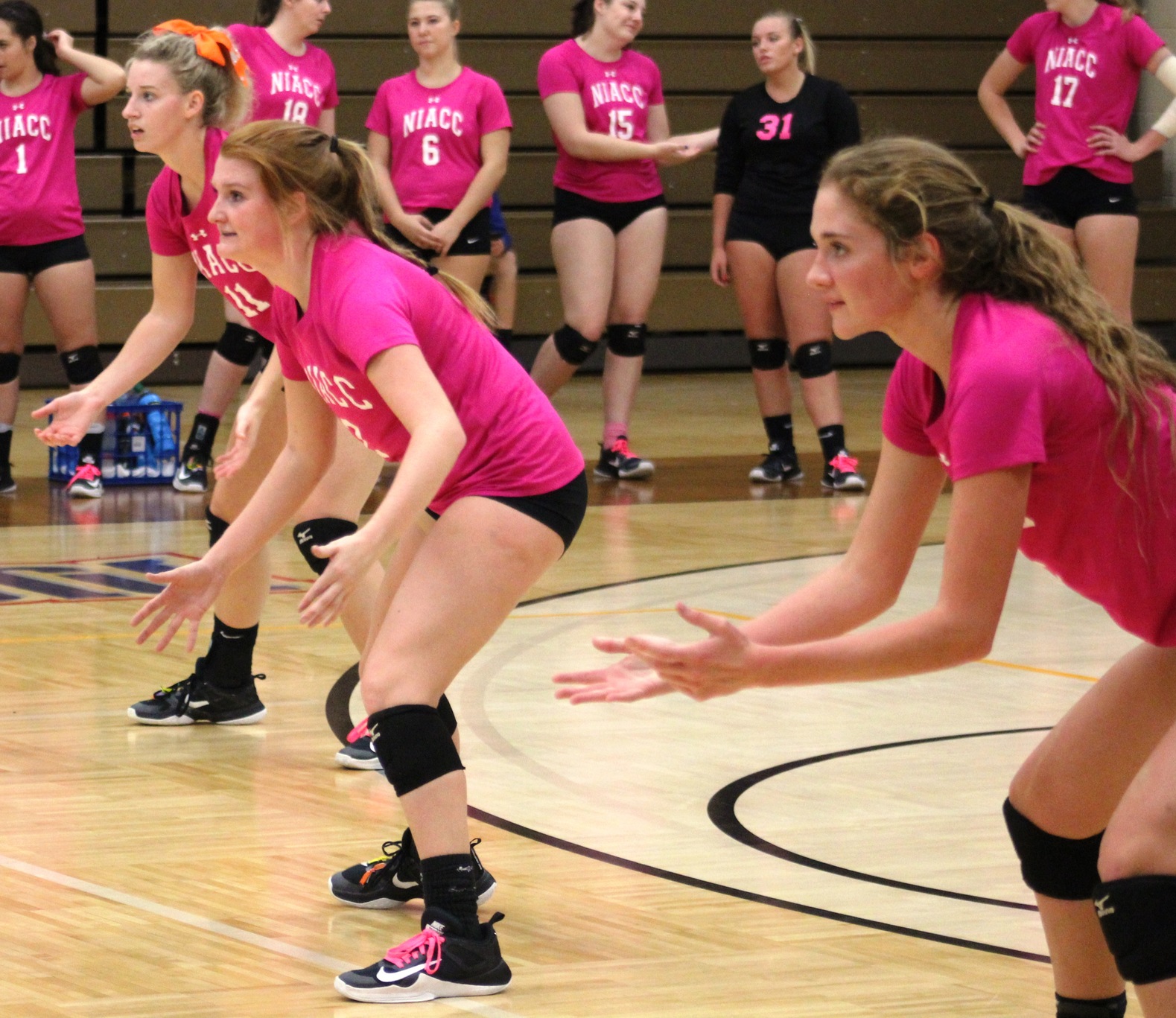 NIACC's Shelby Heston, Connor Gauch and Hannah Wagner get ready for the serve in last Thursday's Think Pink match.