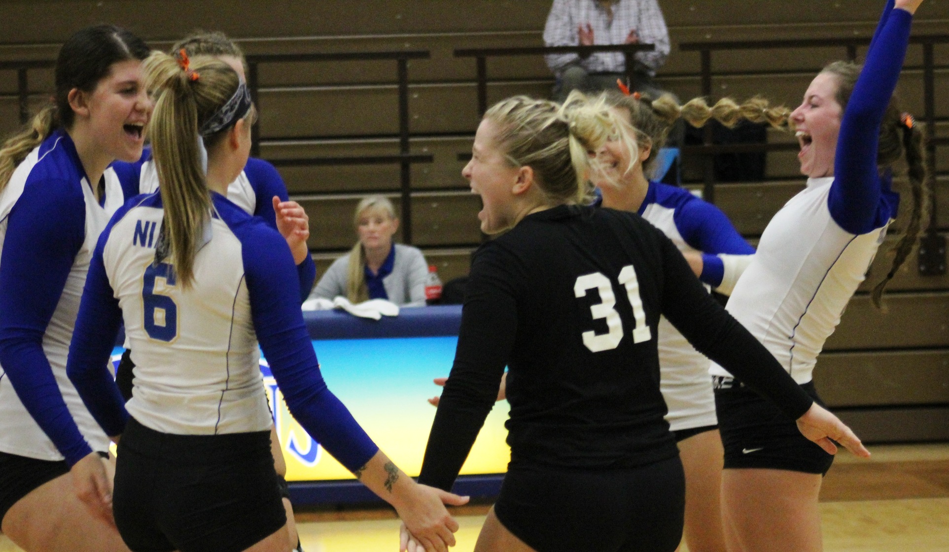 NIACC players celebrate a point in Friday's match against DCTC.