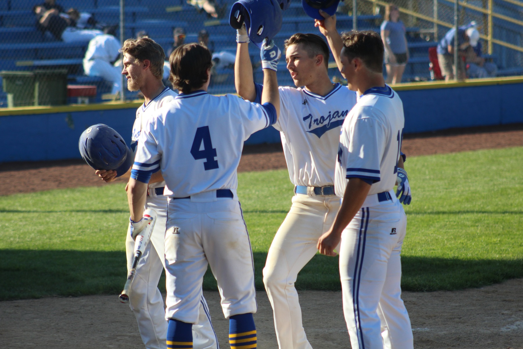 Mitch Neunborn (center) is congratulated at home plate after hitting a 3-run home run in the third inning of Friday's regional tournament game.