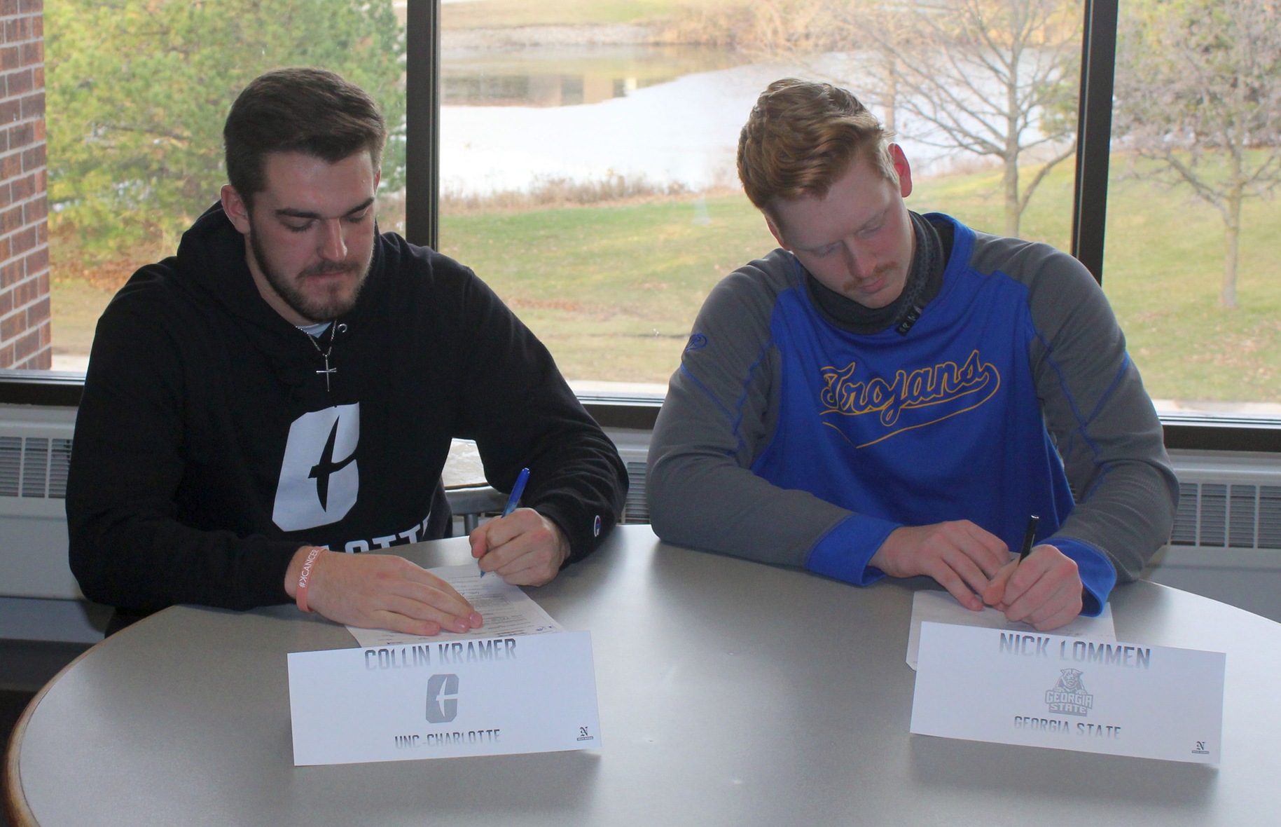 NIACC's Collin Kramer (left) and Nick Lommen sign national letter of intents Wednesday with NCAA Division I schools.