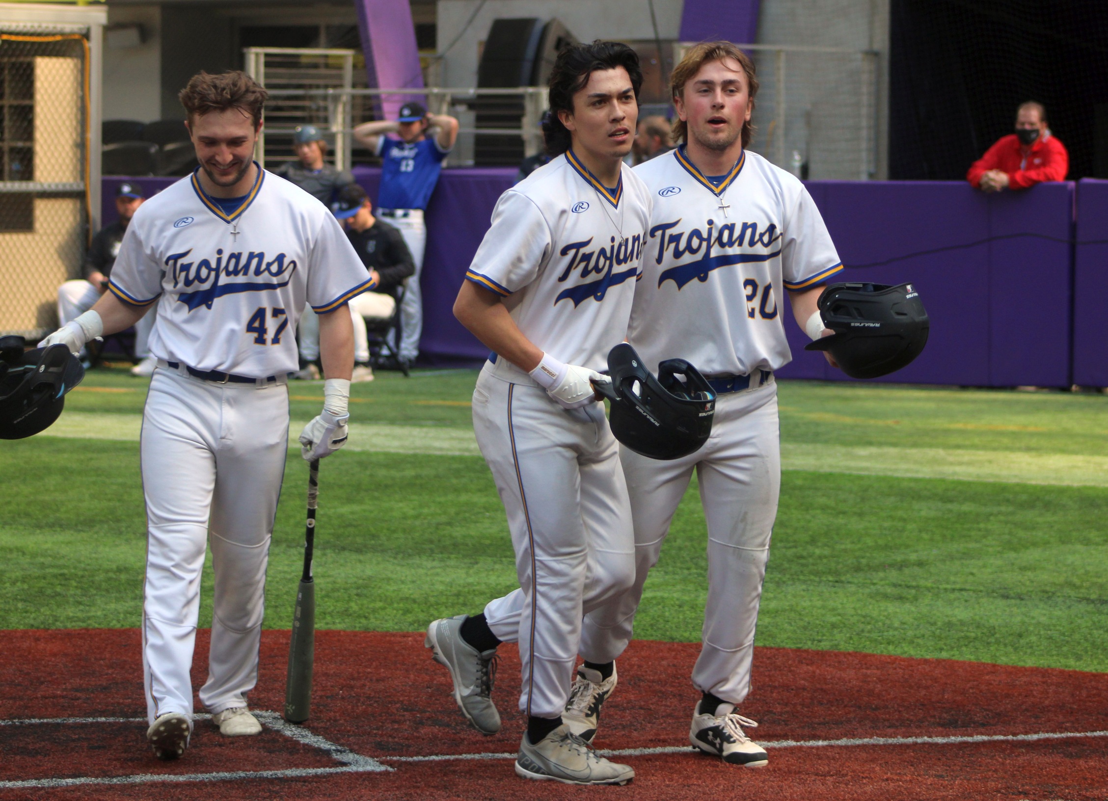 NIACC's Jon Koehn (center) celebrates his two-run home run in the first game of Wednesday's doubleheader against Bryant & Stratton at US Bank in Minneapolis.