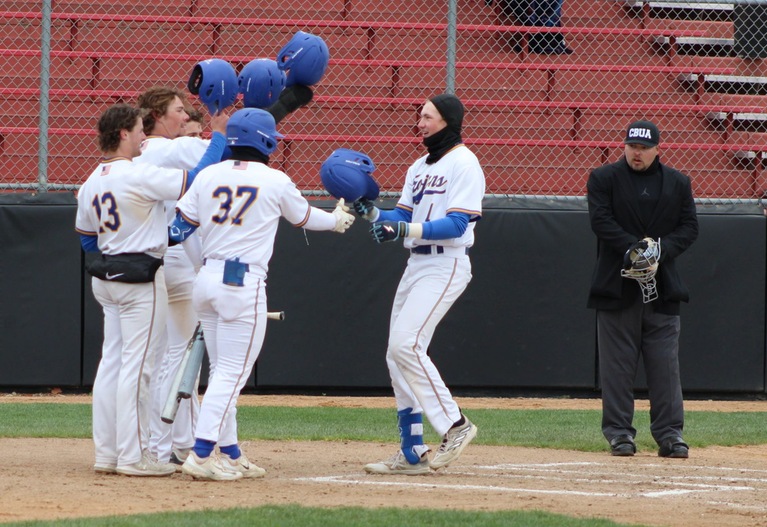 NIACC's Payton Fort is congratulated at home plate after hitting a 3-run home run in Saturday's home game against Marshalltown CC at Roosevelt Field.