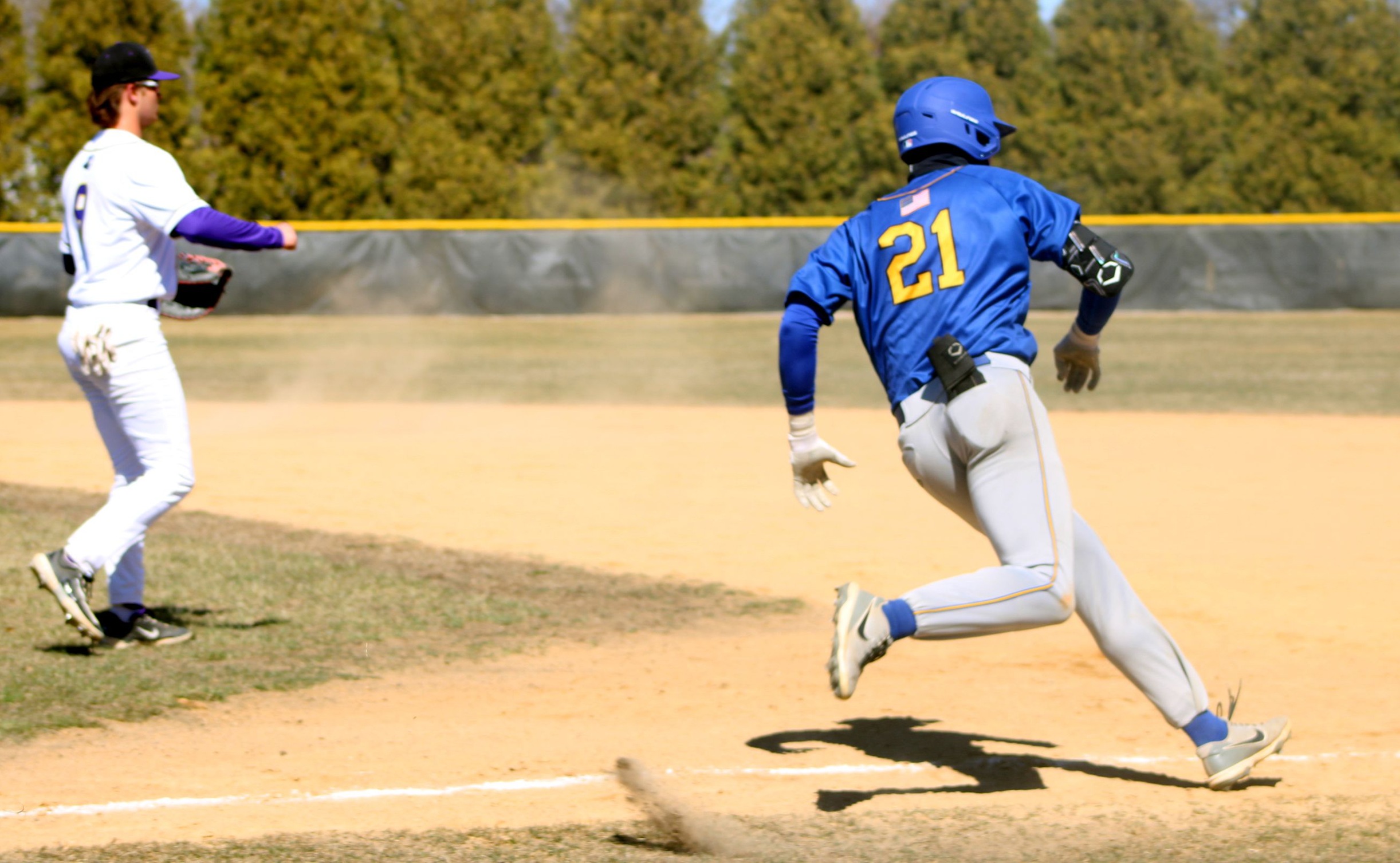 NIACC's Charlie Harms rounds first base with a single in the first game Wednesday against Ellsworth in Iowa Falls.