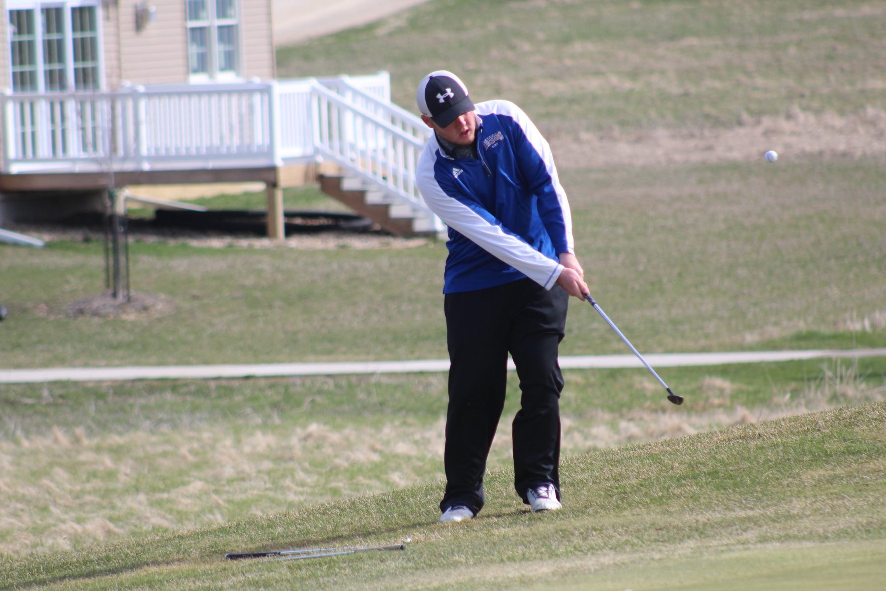 Zach Nicholson chips onto the green on Saturday at the Wartburg Invitational in Waverly.