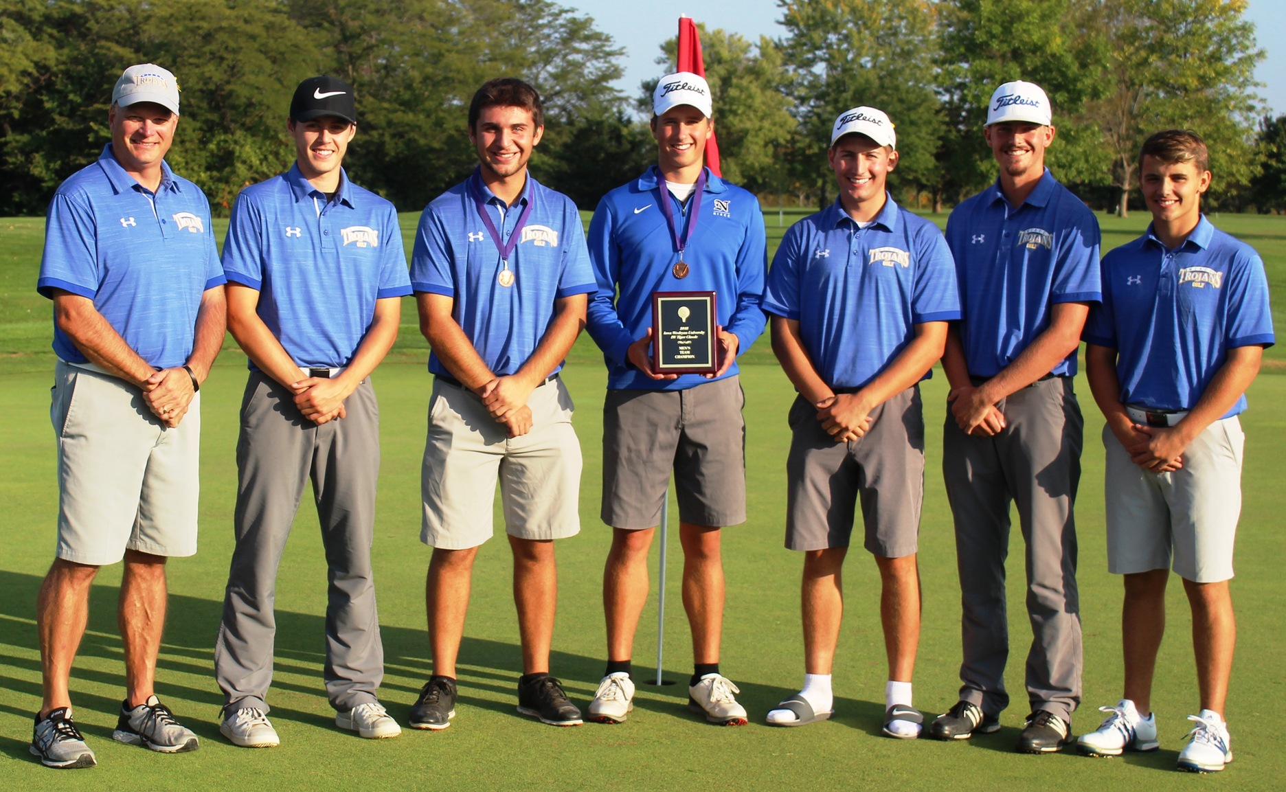 The NIACC men's golf team with its winning plaque at the Iowa Wesleyan Tiger Classic.