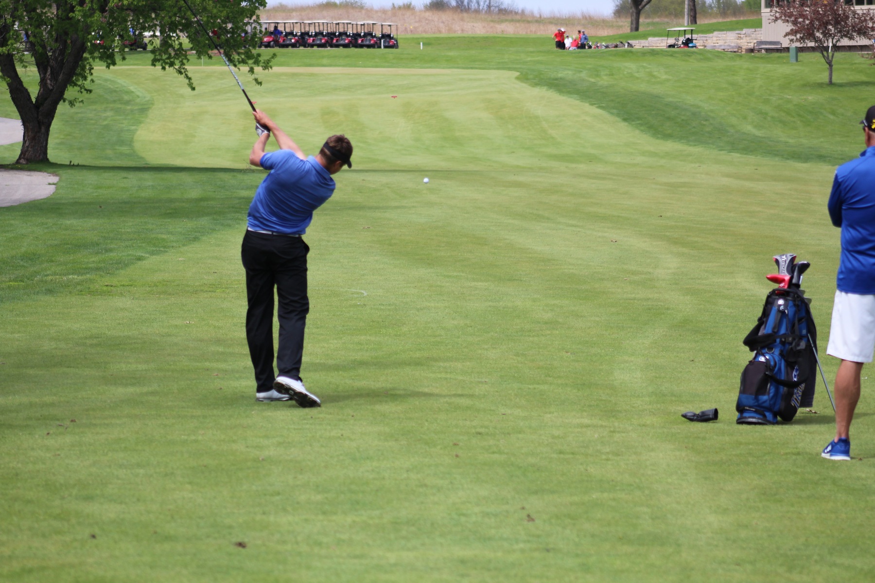 Ben Boerjan hits his second shot toward the 18th green on Monday during the regional tournament in Ames.