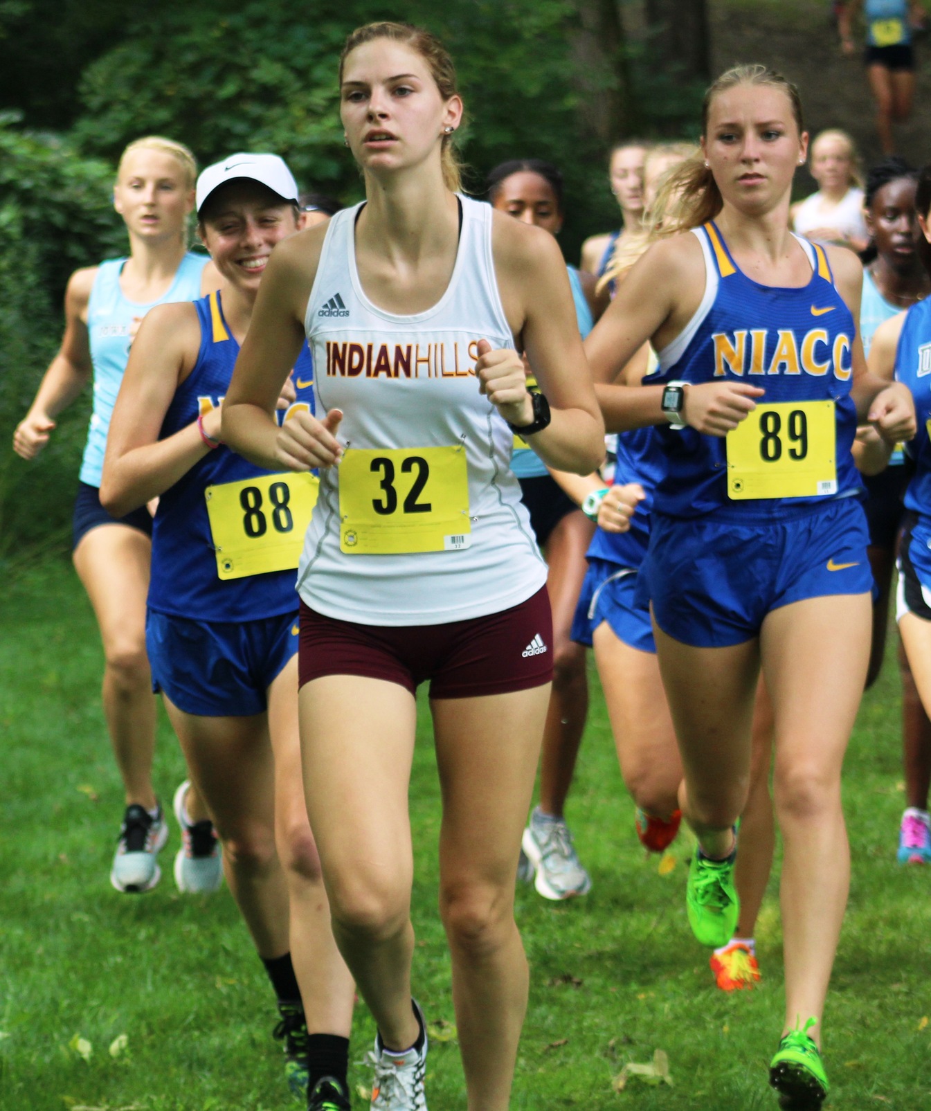 Julia Dunlavey (88) and Cecilia Hemsworth (89) run at the regional time trial on Aug. 25 in Davenport.