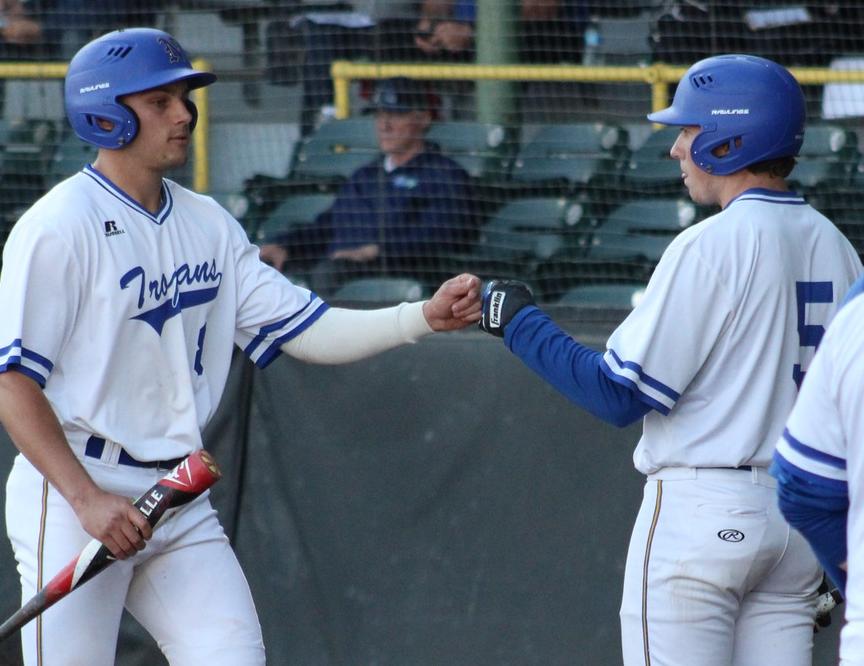 NIACC's Ben Fitzgerald is congratulated by Shane Kelleher after scoring a run in Friday's regional tournament game.