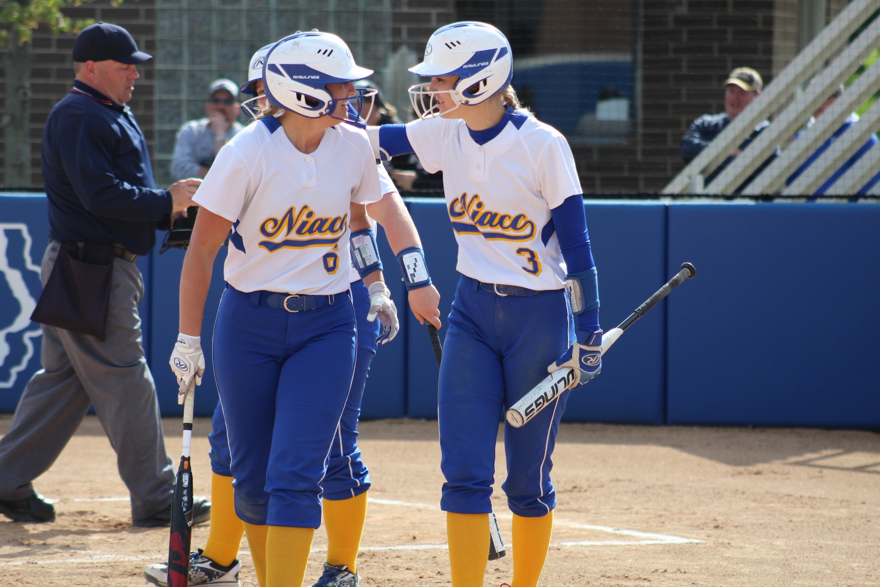 Morgan Kelley (left) gets congratulated by Hannah Faktor after hitting a solo home run in the fourth inning.
