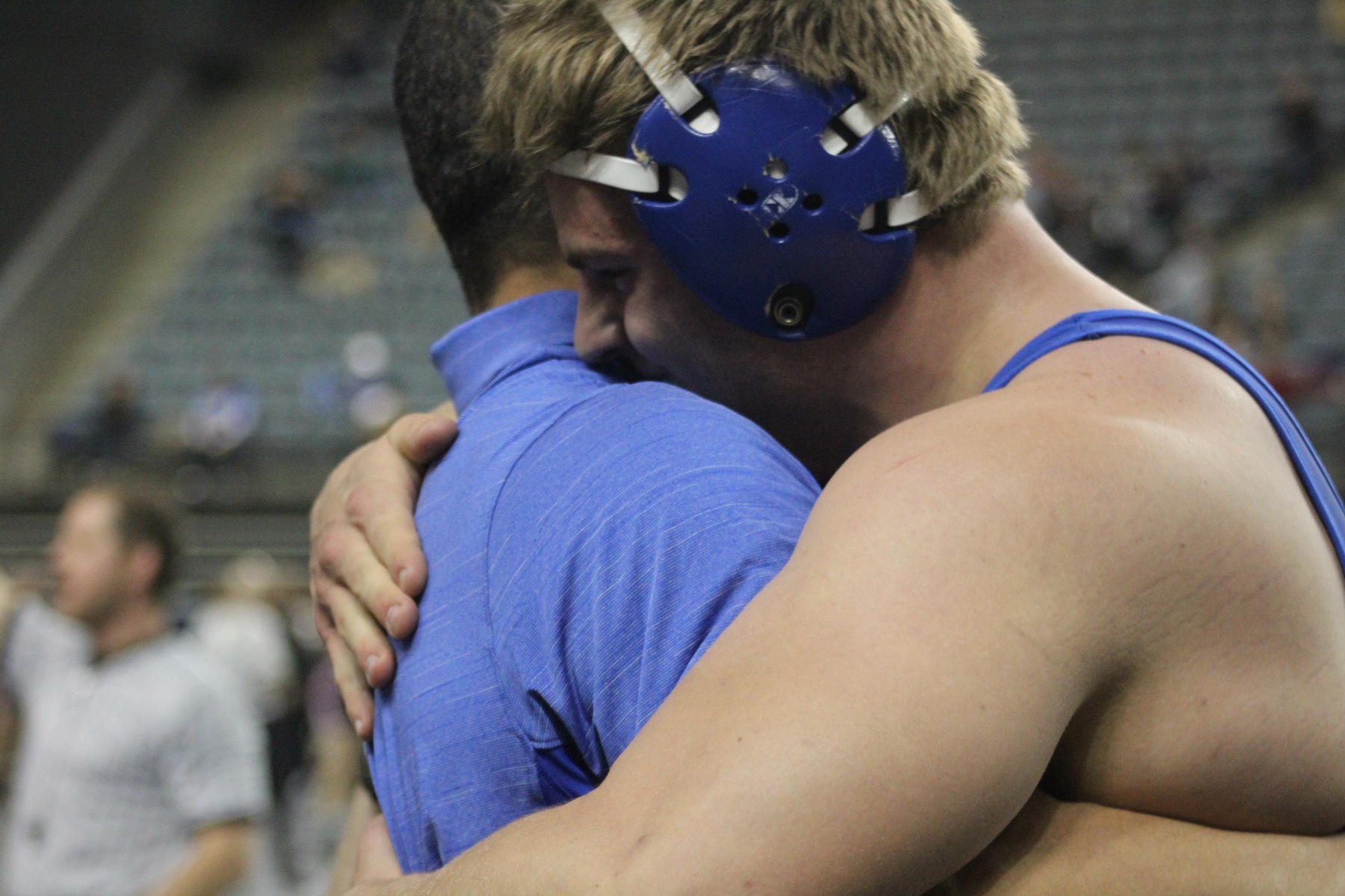 NIACC's Zach Santee hugs assistant coach Basil Minto after winning his 285-pound quarterfinal match Friday.
