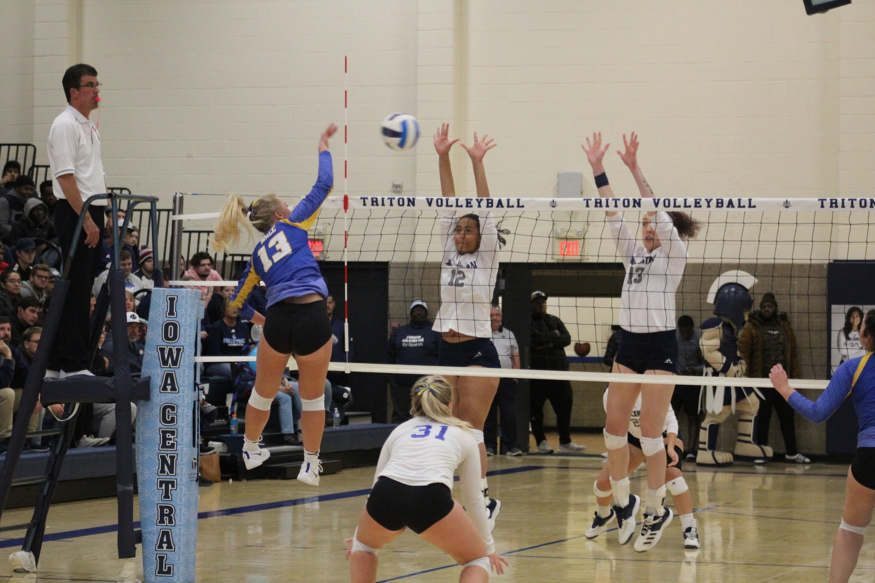 Alexa Loftus hits the ball over the net in Wednesday's match at Iowa Central.