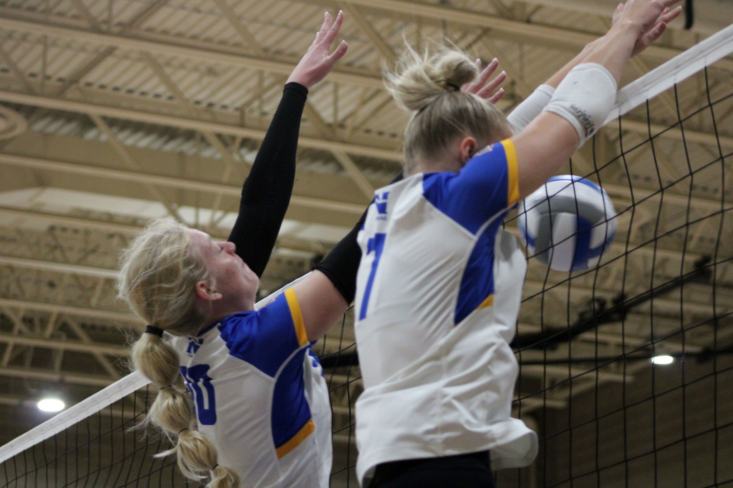 NIACC's Ellie Hanna (left) and Alicia Machacek team up for the block in Saturday's match against Ellsworth.