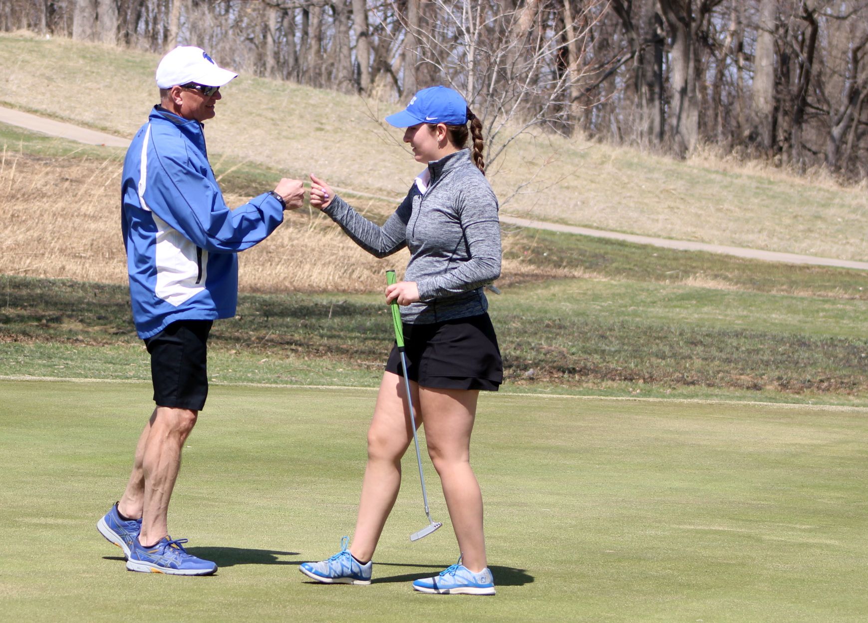 NIACC's Alyssa Alert gets a fist pump from coach Chris Frenz after sinking a putt Saturday at the Iowa Central Spring Invitational.