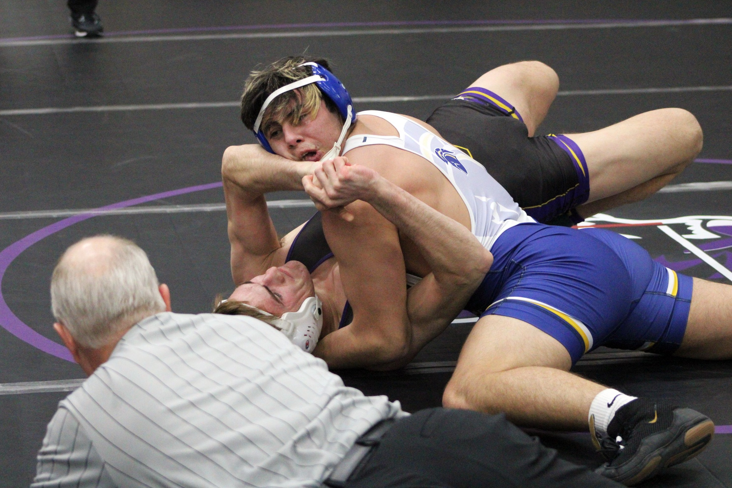 NIACC's Ein Carlos works for the fall against Ellsworth's Brent Greenfield in their 184-pound district title match on Sunday.