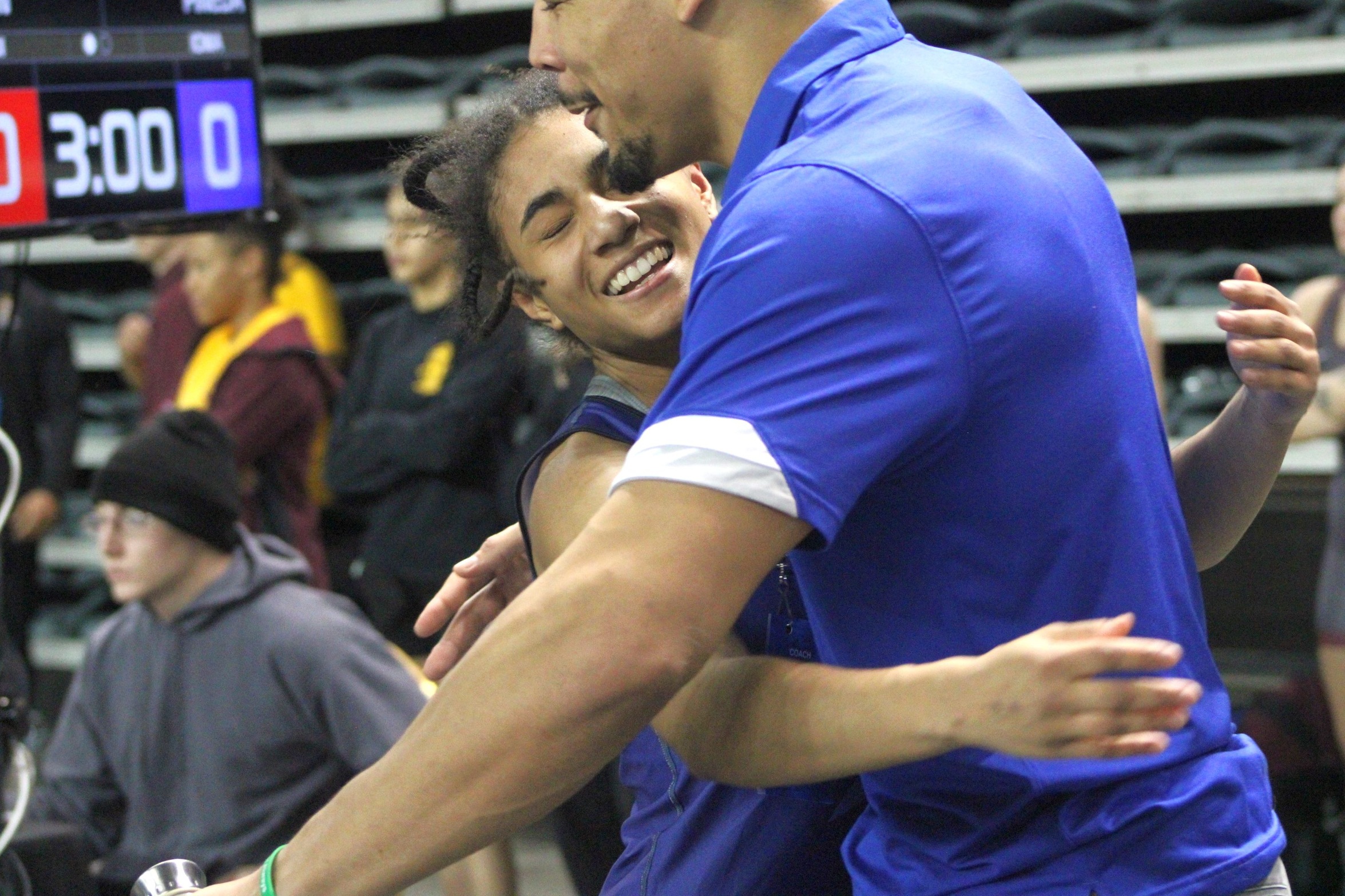 NIACC's Chiara Barbieri hugs her coach Basil Minto after placing third at 101 pounds at the national tournament.