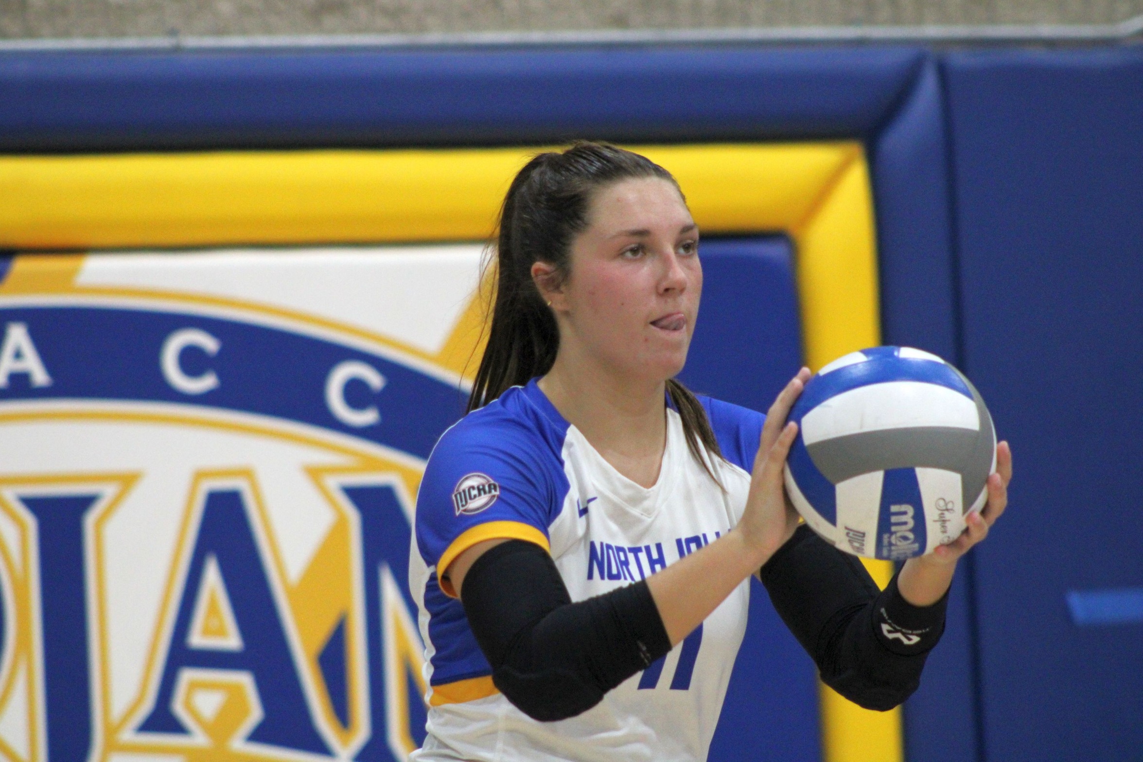 NIACC's Emily Opstvedt prepares to serve in a match against Northeast CC earlier this season.
